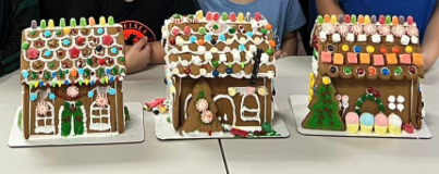 three decorated gingerbread houses