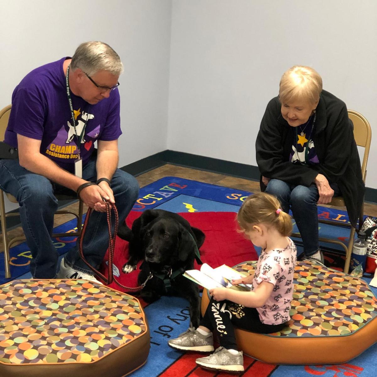 Child reading to a dog. 