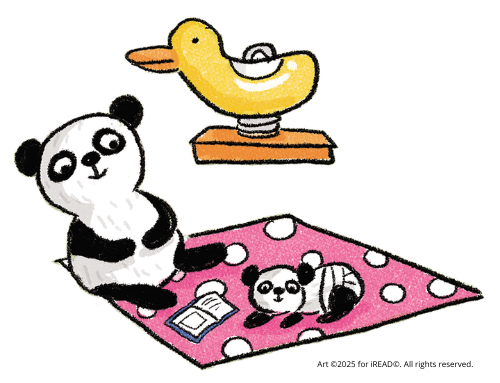 Mama panda reading to baby panda on blanket.